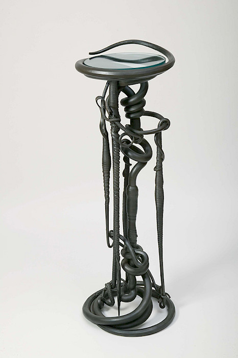 Albert Paley (Philadelphia, Pennsylvania, 1944 - ), "Plant Stand," 1983, forged and fabricated mild steel and glass, 47 1/4 × 16 1/2 × 16 1/2 in., Arkansas Museum of Fine Arts Foundation Collection: Purchase, Decorative Arts Museum Fund. Photography by Edward C. Robison III.