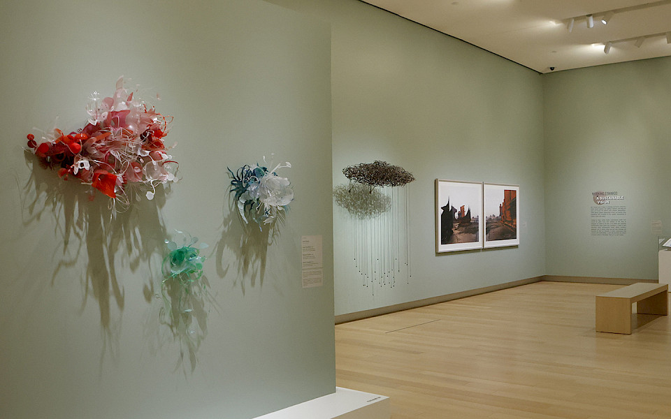 Photo of contemporary sculptures hanging in an art gallery.