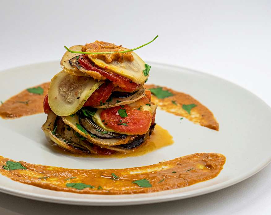 Photo of ratatouille on a white plate.