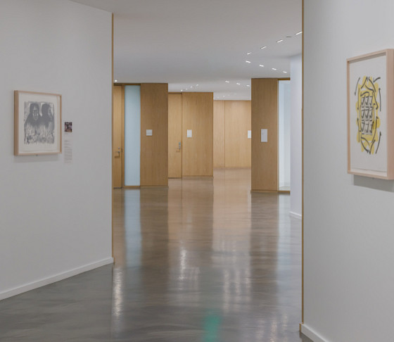 Photo of an empty hallway in the Windgate Art School. Two artworks can be seen hanging on the walls.