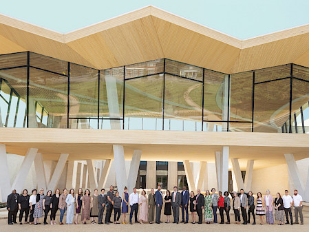 Photo of a large group of AMFA staff members standing in front of the North Entrance to the new Museum.